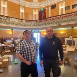 Smedley and Mario in Bridgwater Town Hall, sorting donations for Ukraine.